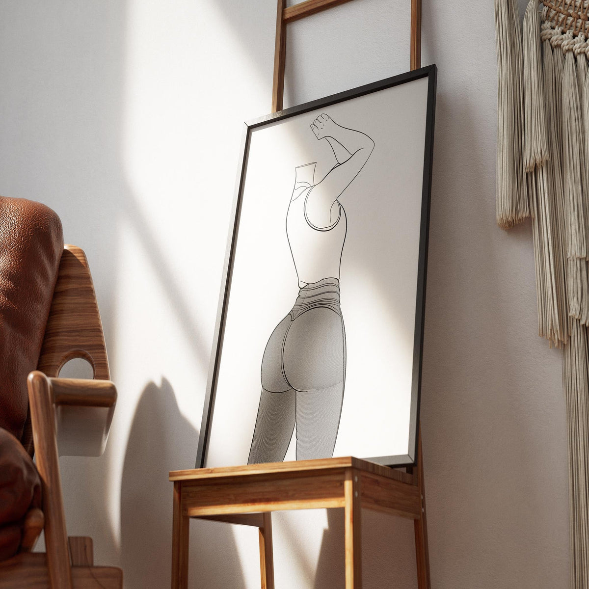 Framed line art of a character in jeans, showcasing digitalized design in a relaxed room setting.