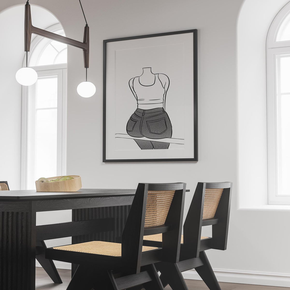 Black and white line art poster of person in jeans on display in modern dining room.